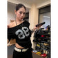 Off shoulder black number tee