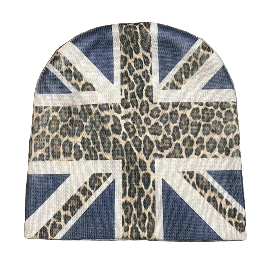 A beanie hat featuring a Union Jack flag design overlaid with a leopard print pattern, photographed flat on a textured concrete surface.